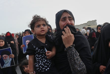 A woman weeps during a mass funeral in Kuhestak.Photograph: Razieh Poudat/AP