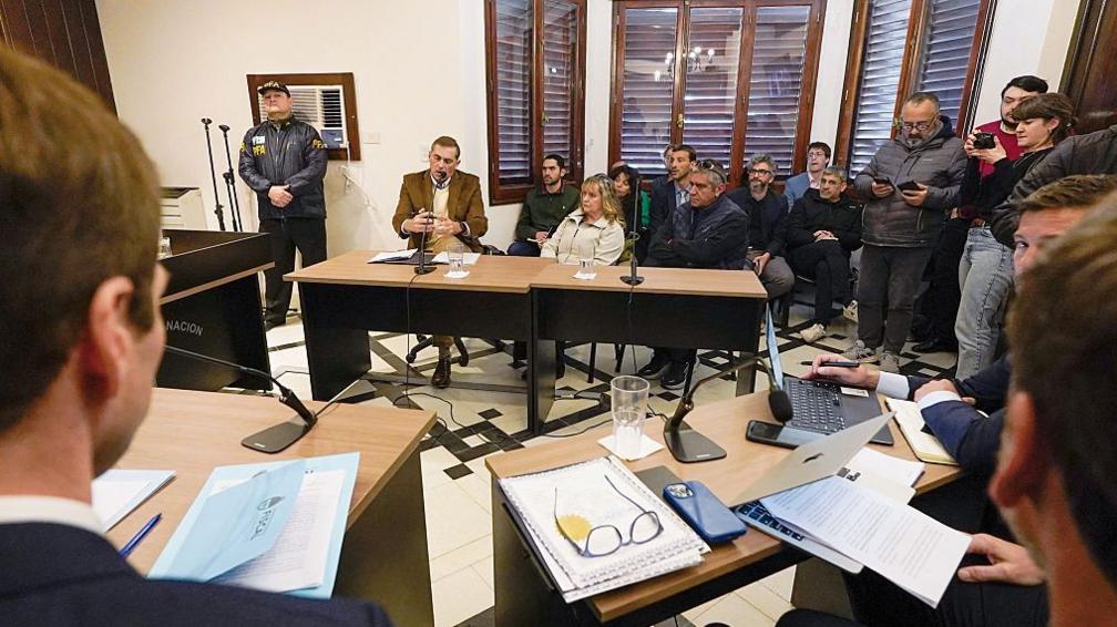 Image caption,Patricia Kadgien and her husband Juan Carlos Cortegoso appeared alongside their lawyer in a court near Buenos Aires on Friday