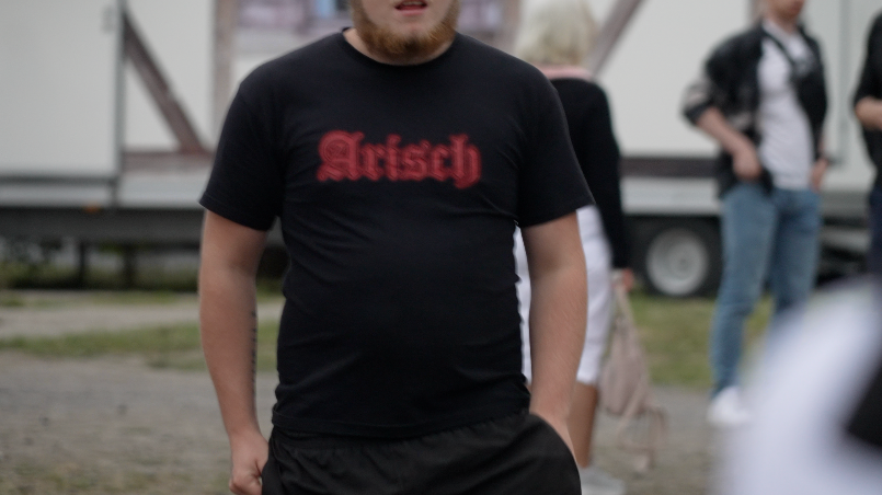 Image caption,An attendee at an AfD rally covered by the BBC wore a T-shirt withArisch, the German word for Aryan written on it