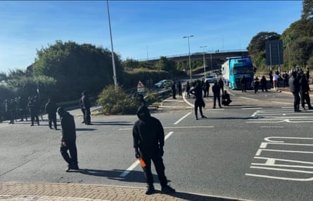 Balaclava-wearing protesters gather earlier on Saturday.Photograph: Ay_audits/YouTube
