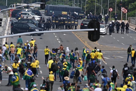 Supporters of Jair Bolsonaro face off with police Brasília in January 2023 in a demonstration calling for the overthrow of President Lula.Photograph: André Borges/EPA