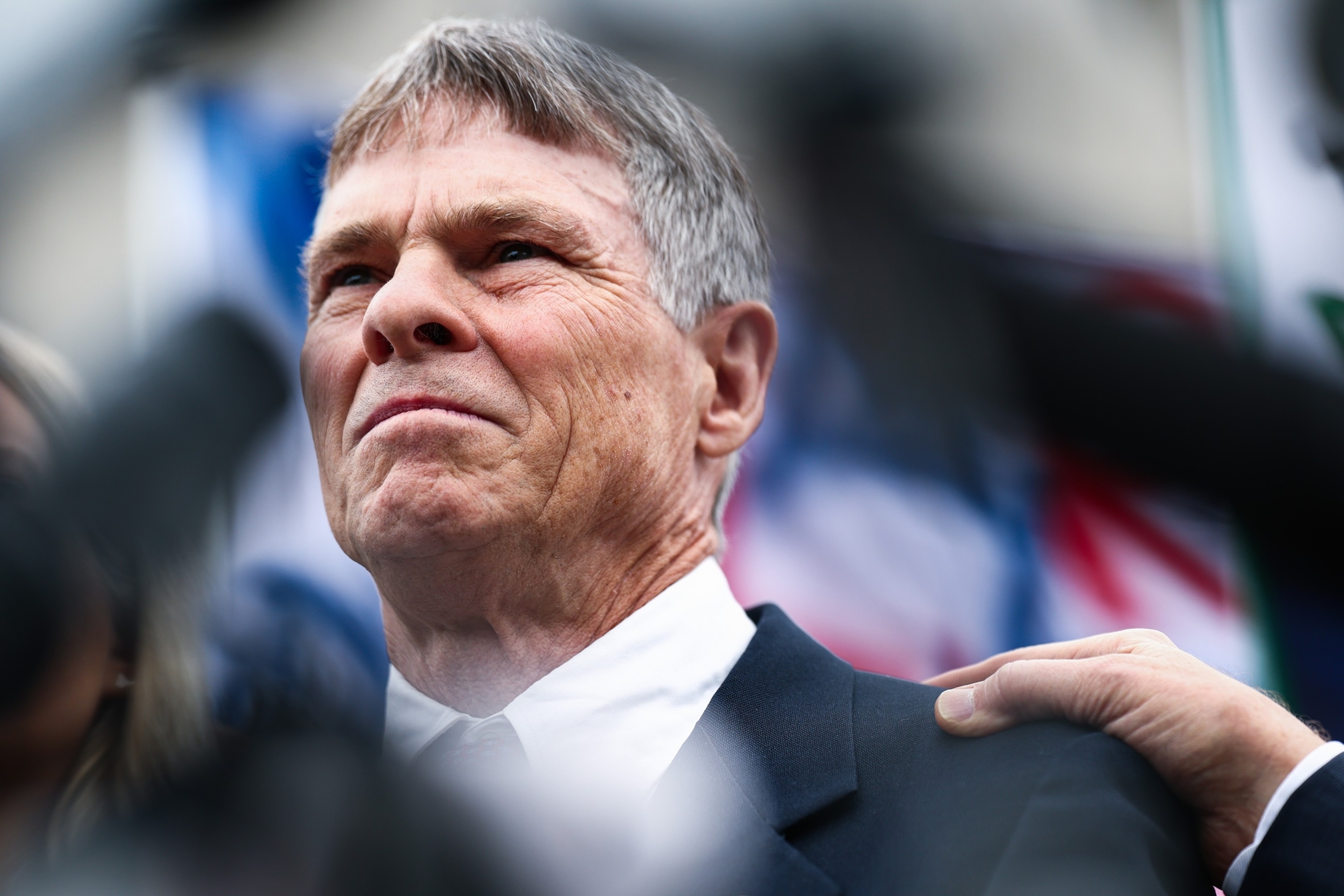 Former Olympian David Hearn stands with his attorney Norman Eisen as he speaks to reporters and protestors gathered after his arraignment at Moultrie Courthouse, July 9, 2026, in Washington, D.C.Finn Gomez/Getty Images