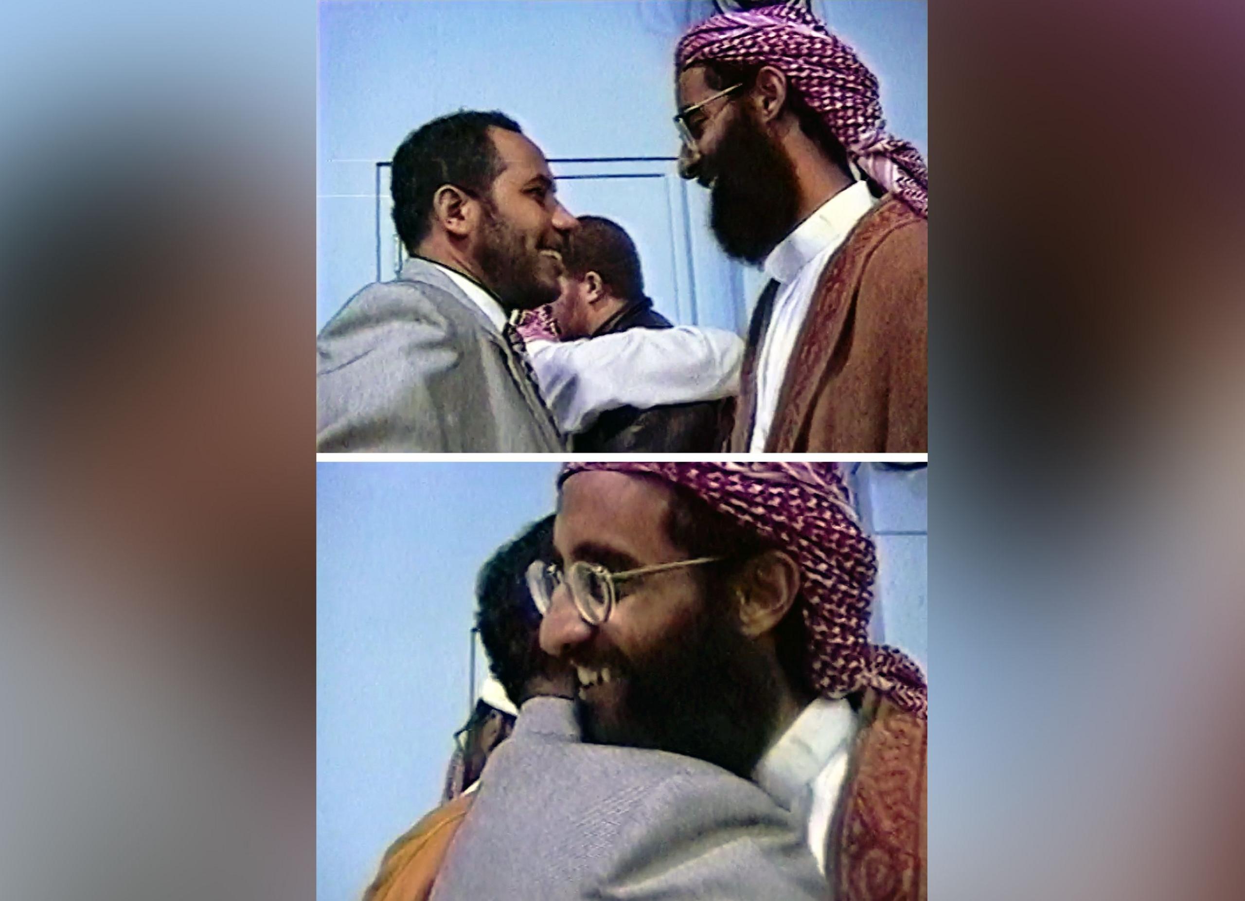 Image caption,Stills from another video show Bayoumi and Awlaki embracing