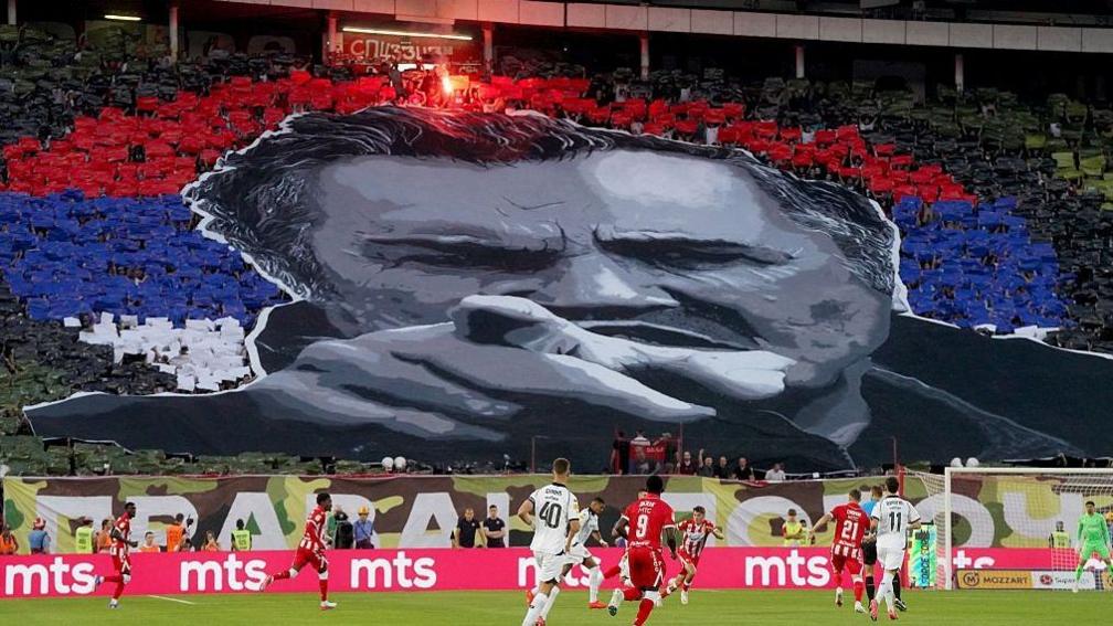 Image caption,The night before the funeral, Red Star Belgrade supporters formed a tifo depicting Mladić during the Serbian SuperLiga football match
