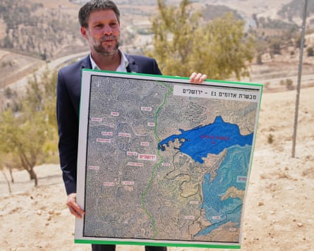 Israel’s finance minister, Bezalel Smotrich, holds up a map showing the E1 settlement project.Photograph: Ohad Zwigenberg/AP