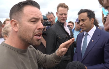 Daniel Thomas, left, speaking to the Reform UK home affairs spokesperson, Zia Yusuf (right, in blue suit), has claimed to have arranged the demonstration.Photograph: Theo Shaw/PA
