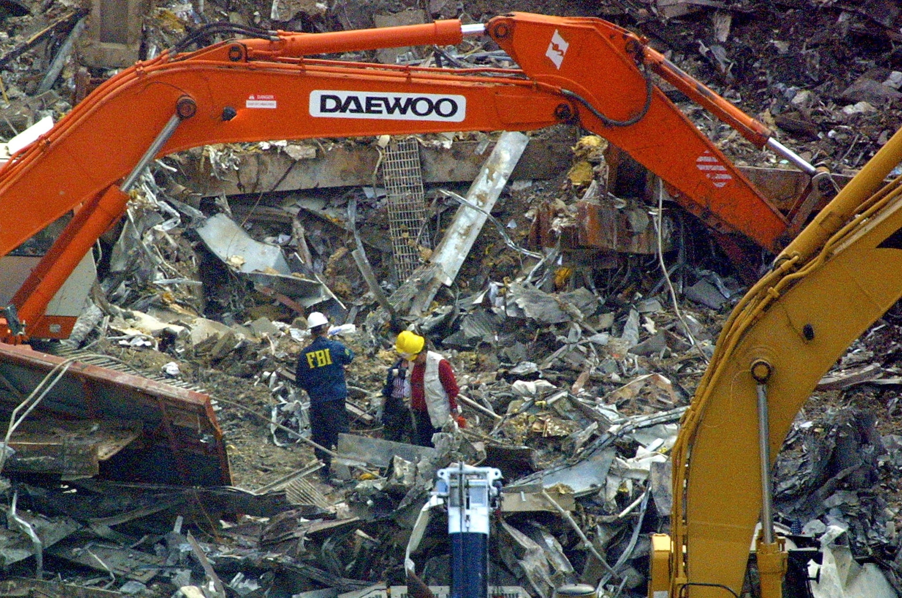 An FBI agent is among those searching the rubble in the remains of the World Trade Center, Sept. 17, 2001 in New York, nearly a week after the terrorist attack on the World Trade Center.Doug Kanter/AFP via Getty Images