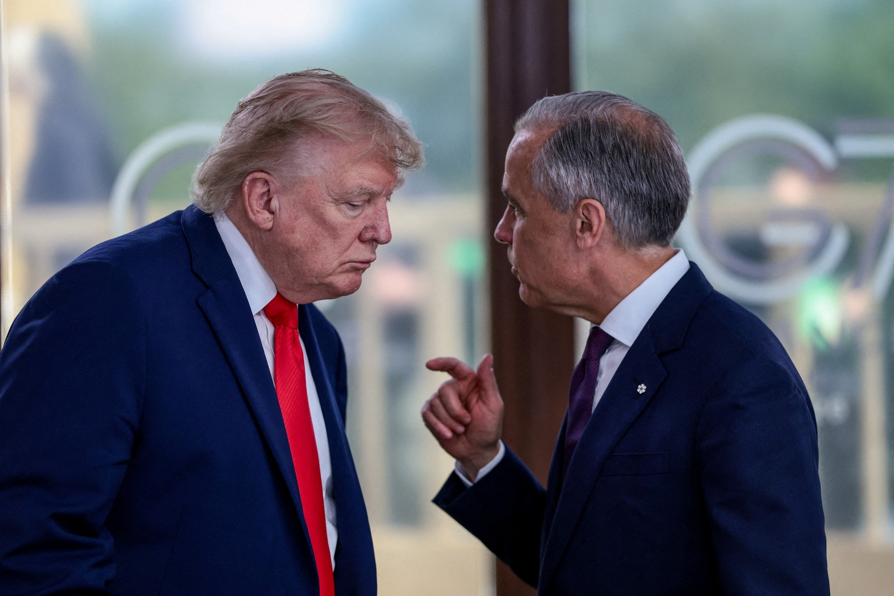 President Donald Trump speaks with Canadian Prime Minister Mark Carney at a working lunch with leaders of G7 and the Middle East, in Evian-les-Bains, France, June 16, 2026.Evelyn Hockstein/Reuters, FILE