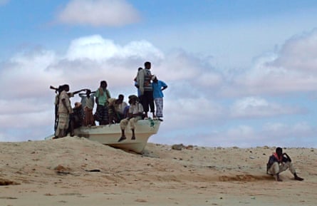 Armed Somali pirates guard the beach in Hobyo district, 540km north-east of Mogadishu, in 2008.Photograph: Badri Media/epa/Corbis