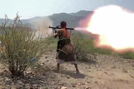 A screen grab taken from footage released by the Saudi-backed National Resistance Forces in Yemen on Tuesday shows a fighter firing a grenade towards Houthi fighters.Photograph: Yemen National Resistance Forces/AFP/Getty Images