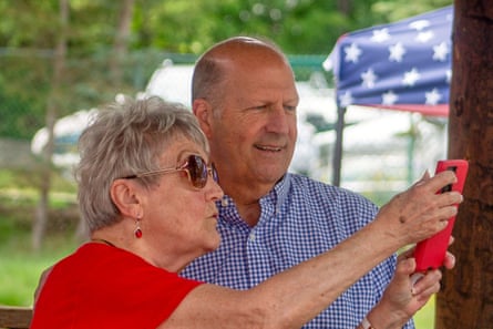 Former senator John E Sununu, who is seeking the GOP nomination for his old seat, takes a selfie with a supporter in Berlin, New Hampshire on 22 August.Photograph: Holly Ramer/AP