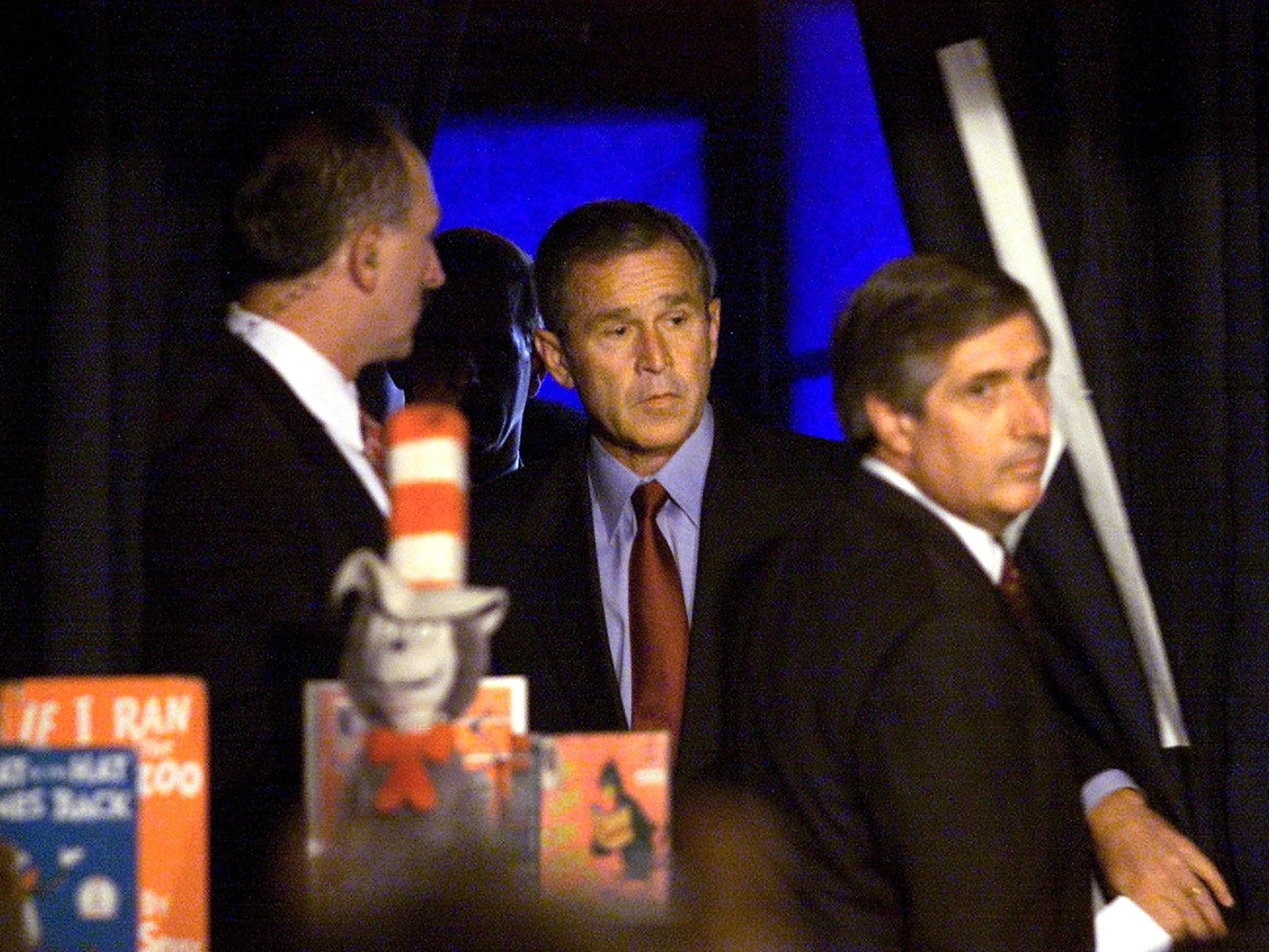 President George W. Bush steps through a curtain led by his Chief of Staff Andrew Card to address the nation shortly after the attack on the Word Trade Center in New York City, in Sarasota, Florida, September 11, 2001.Paul J. Richards/AFP via Getty Images