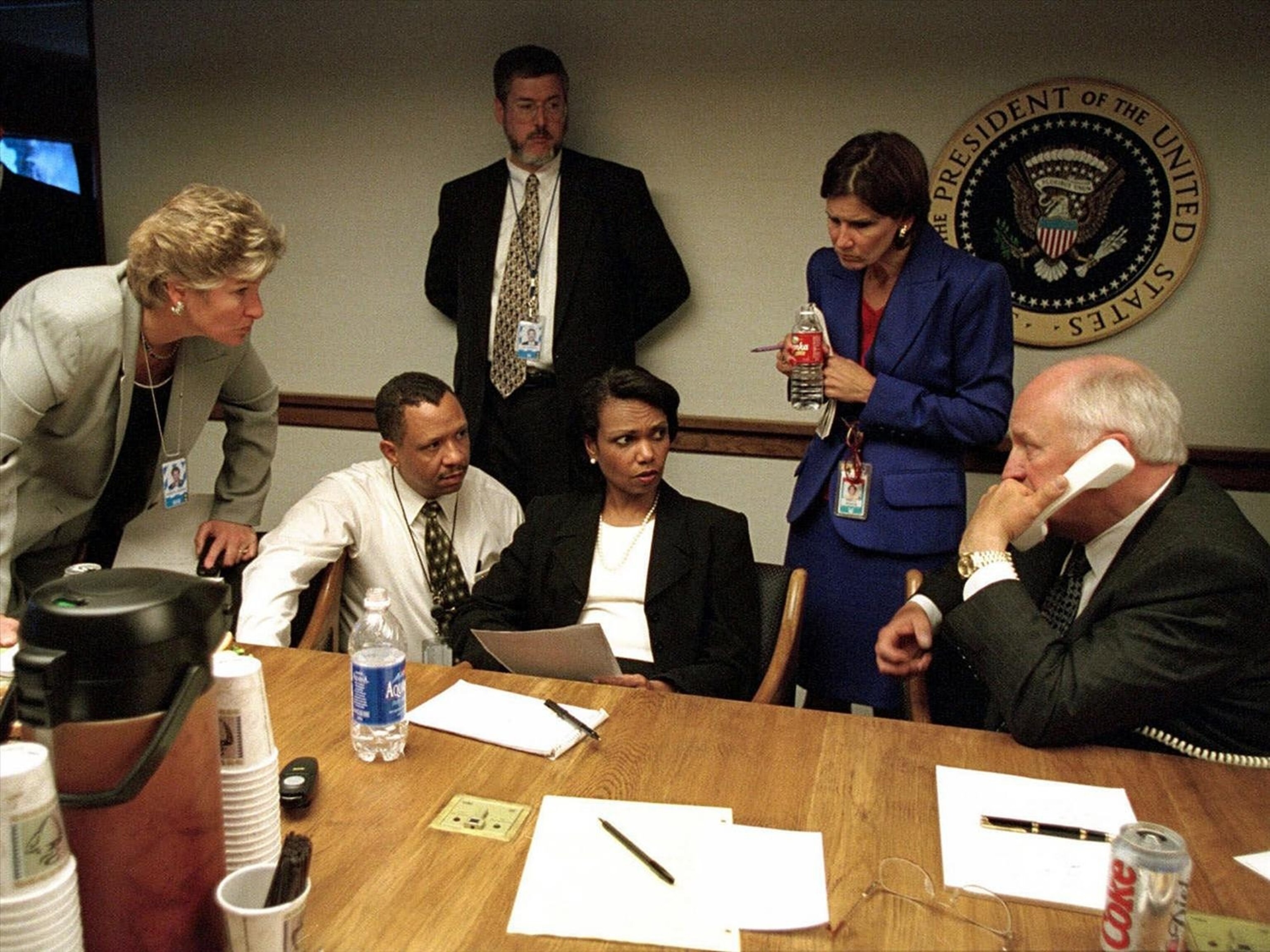 Vice President Dick Cheney speaks to President George W. Bush by phone inside the operations center at The White House just after September 11th terrorist attacks, as staff members Karen Hughes and National Security Adviser Condoleezza Rice (c) look on in Washington, Sept. 11, 2001.The White House/AP