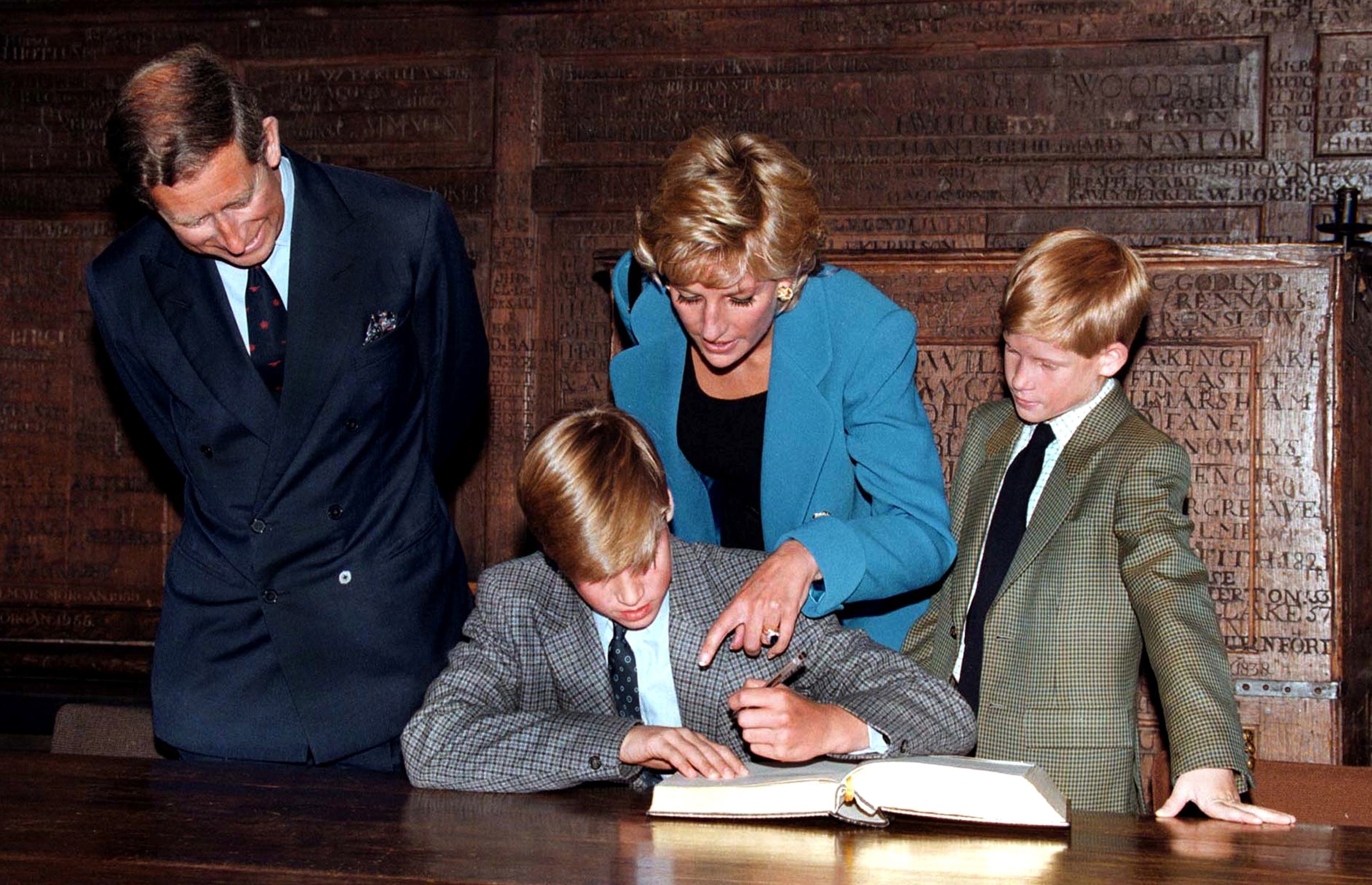 Prince William follows Eton tradition by signing a book before starting at the school, as Prince Charles, Princess Diana and Prince Harry look on, Sept. 6, 1995.Jayne Fincher/Getty Image