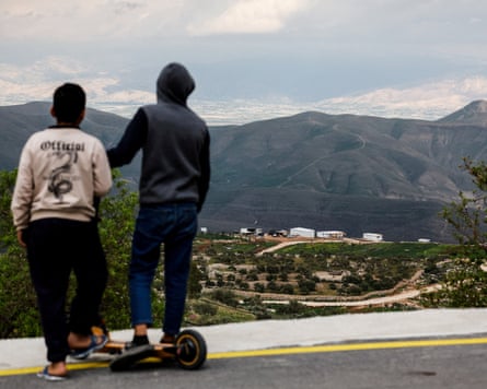 Young Palestinians look at a new Israeli settlement from the Palestinian village of Duma, near Nablus, in the Israeli-occupied West Bank in February 2026.Photograph: Ammar Awad/Reuters