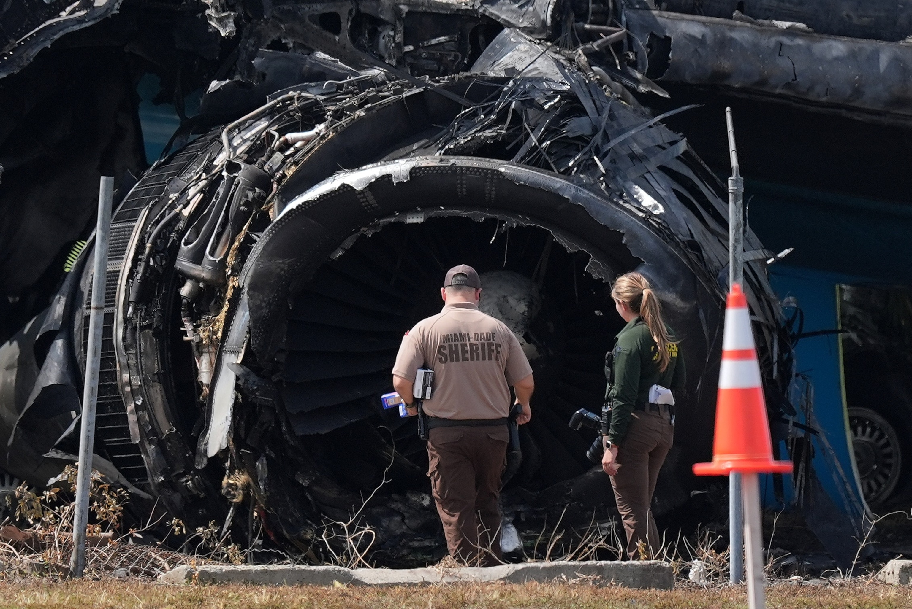 Law enforcement officers walk in front of a destroyed engine as they inspect an Amazon cargo plane two days after it overshot a runway at Miami International Airport, Tuesday, Sept. 8, 2026, in Miami.Rebecca Blackwell/AP Photo