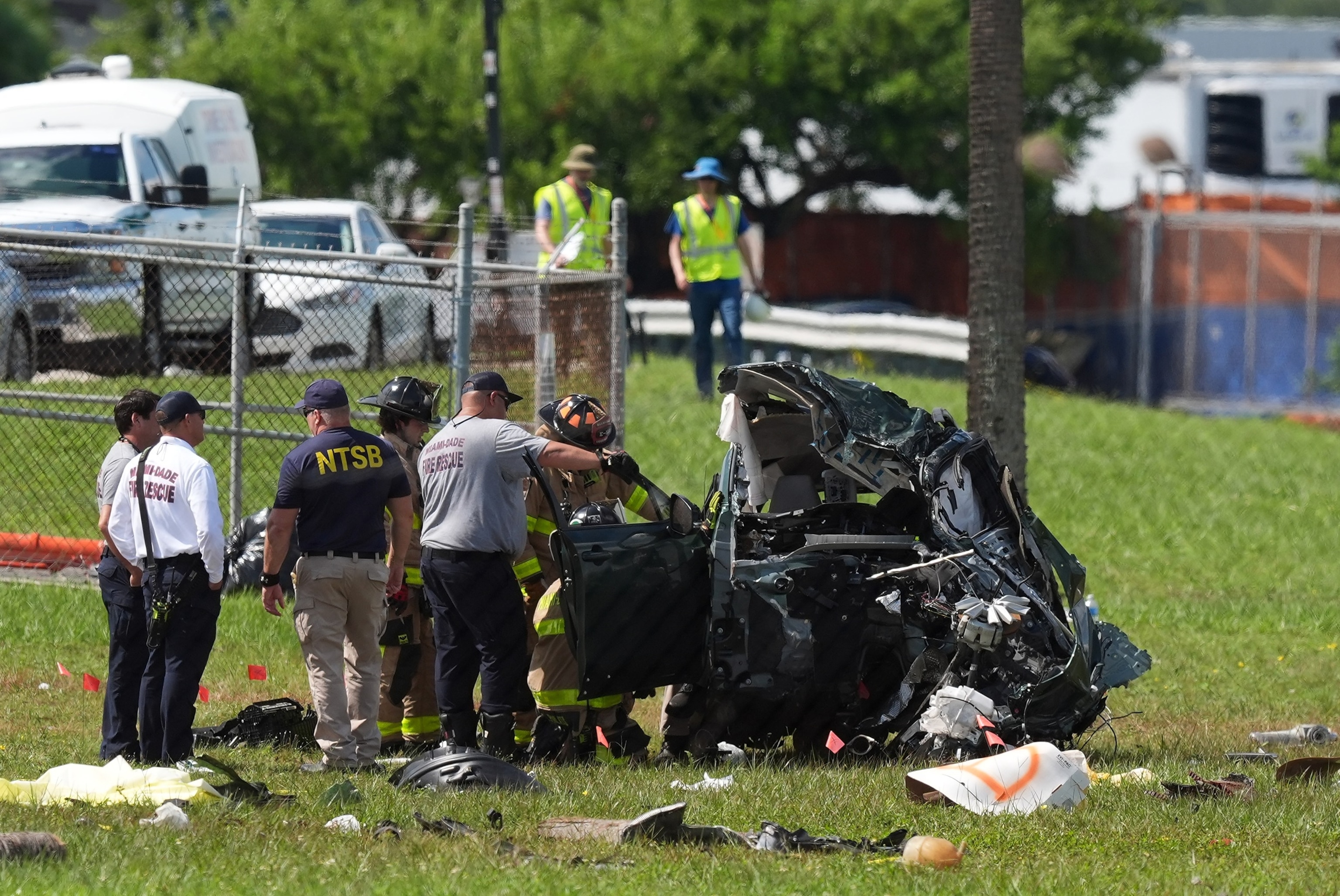 Officials inspect a vehicle that was destroyed two days earlier when an Amazon cargo plane overshot a runway at Miami International Airport, Tuesday, Sept. 8, 2026, in Miami.Rebecca Blackwell/AP Photo