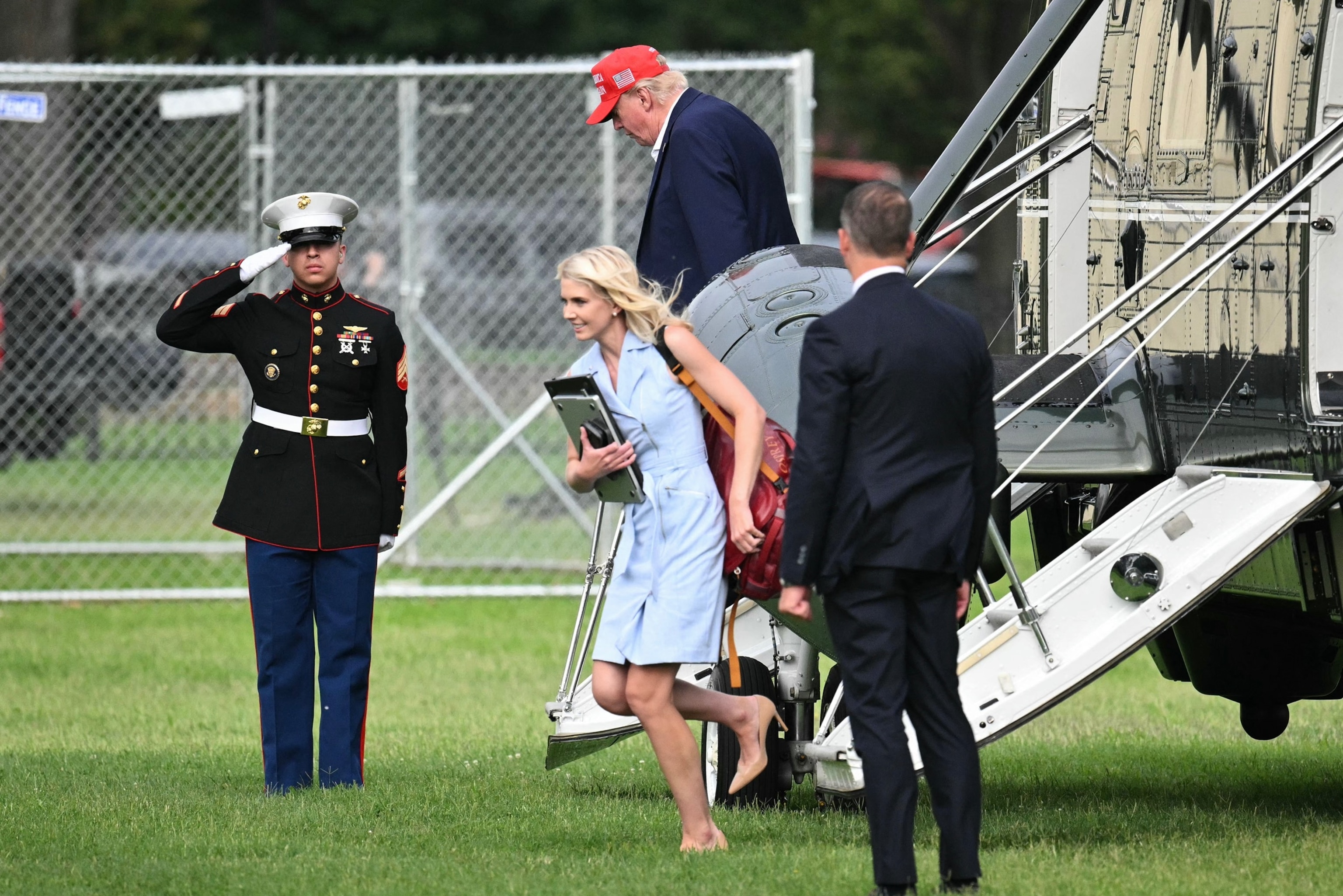 US President Donald Trump and aide Natalie Harp exit Marine One on the Ellipse near the White House on August 16, 2026. President Trump is returning to the White House after spending the weekend at his golf club in New Jersey.Mandel Ngan/AFP via Getty Images